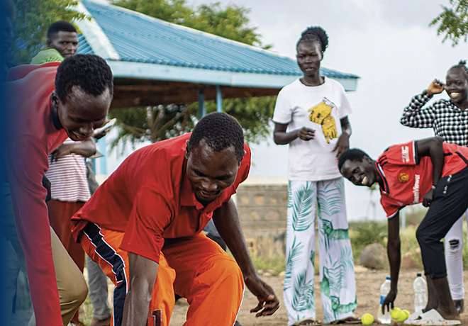 A coach leading a group of children in a community session