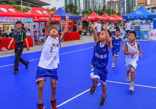 Children playing basketball on an outdoor city court
