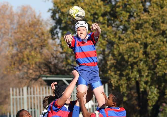 Young players competing in a rugby match